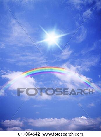 Stock Image - View of sky with sunlight and rainbow. Fotosearch
