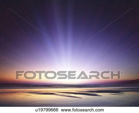 Stock Photograph - View of sun rays and sea. Fotosearch