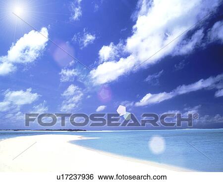 Stock Photograph - View of sunlight over beach. Fotosearch