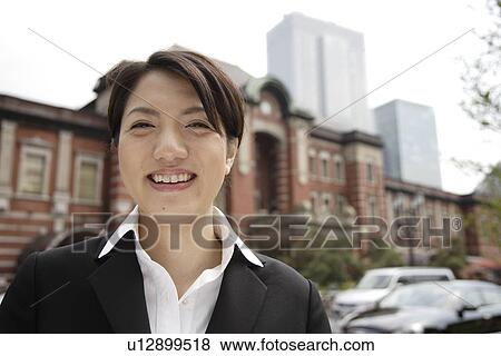 Portrait of a smiling young woman View Large Photo Image Stock Photo - Portrait of a smiling young woman. Fotosearch