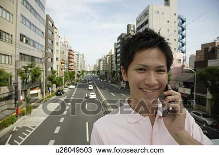 Portrait of a young man talking on mobile phone View Large Photo Image Stock Image - Portrait of a young man talking on mobile phone. Fotosearch