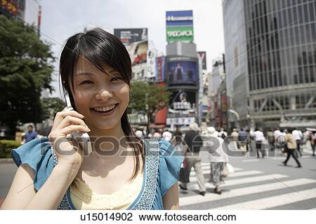 Portrait of a young woman talking on mobile phone View Large Photo Image Stock Image - Portrait of a young woman talking on mobile phone. Fotosearch