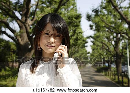 Portrait of a young woman talking on mobile phone View Large Photo Image Stock Image - Portrait of a young woman talking on mobile phone. Fotosearch