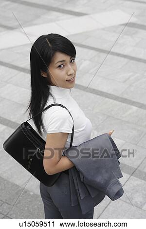 A woman waiting for someone as she looks at the camera View Large Photo Image Stock Image - A woman waiting for someone as she looks at the camera. Fotosearch
