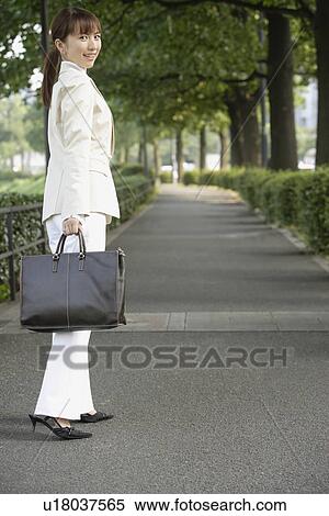 View of a professional woman with a handbag View Large Photo Image Stock Photography - View of a professional woman with a handbag. Fotosearch
