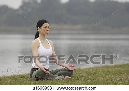 Front view of a woman in lotus position View Large Photo Image Stock Image - Front view of a woman in lotus position. Fotosearch