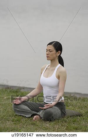 Front view of a woman in lotus position View Large Photo Image Stock Photo - Front view of a woman in lotus position. Fotosearch