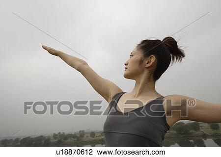 Front view of a young woman exercising. View Large Photo Image Stock Image - Front view of a young woman exercising.. Fotosearch
