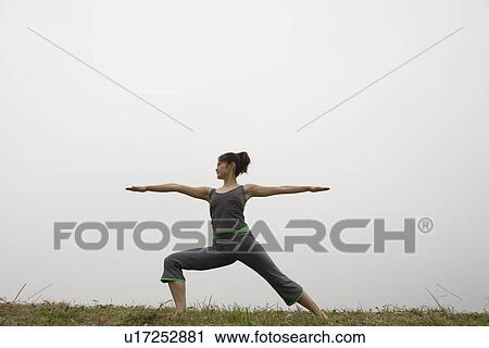 View of a young woman balancing on one leg View Large Photo Image Stock Image - View of a young woman balancing on one leg. Fotosearch