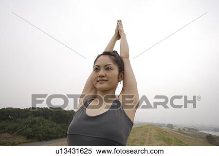 View of a young woman exercising on the ground View Large Photo Image Stock Photography - View of a young woman exercising on the ground. Fotosearch