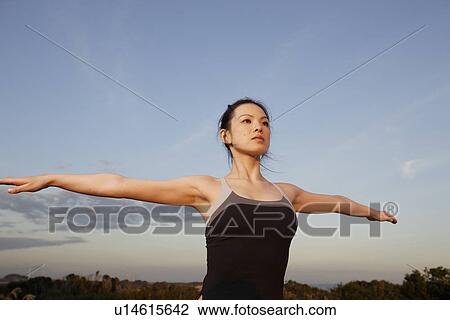 View of a young woman exercising outdoors View Large Photo Image Stock Image - View of a young woman exercising outdoors. Fotosearch