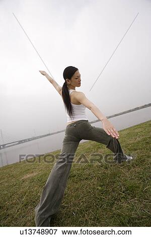 View of a young woman exercising outdoors View Large Photo Image Stock Photo - View of a young woman exercising outdoors. Fotosearch