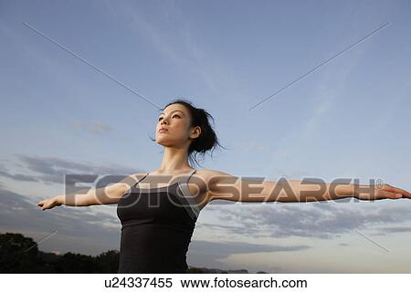View of a young woman exercising outdoors View Large Photo Image Stock Photography - View of a young woman exercising outdoors. Fotosearch