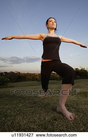 Stock Photo - View of a young woman stretching. Fotosearch