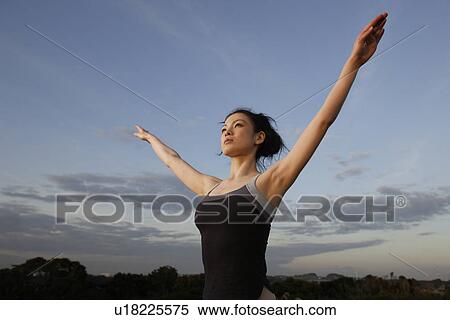 View of a young woman with hands raised View Large Photo Image Stock Photography - View of a young woman with hands raised. Fotosearch