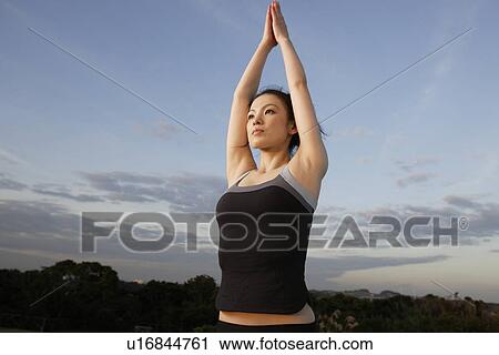 View of a young woman with joined hands View Large Photo Image Stock Image - View of a young woman with joined hands. Fotosearch