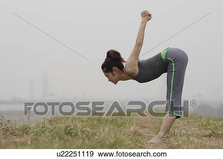 View of young woman exercising outdoors View Large Photo Image Stock Photo - View of young woman exercising outdoors. Fotosearch