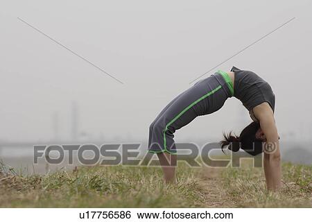 View of young woman exercising outdoors View Large Photo Image Stock Photograph - View of young woman exercising outdoors. Fotosearch