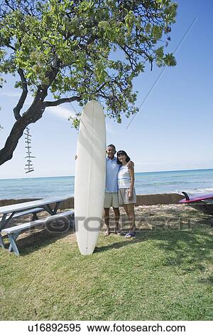 A couple with surfboard smiling View Large Photo Image Stock Photography - A couple with surfboard smiling. Fotosearch
