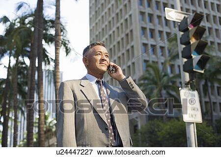 Businessman using mobile phone View Large Photo Image Stock Photo - Businessman using mobile phone. Fotosearch