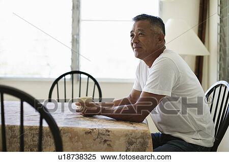 Mature man sitting on chair View Large Photo Image Stock Photography - Mature man sitting on chair. Fotosearch