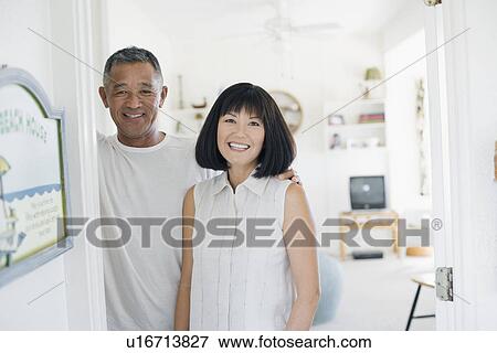 Stock Photo - View of a couple smiling. Fotosearch