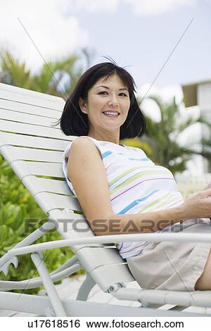 Stock Photograph - View of a smiling woman. Fotosearch