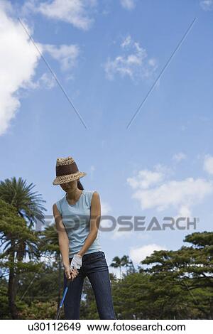 A woman holding golf club View Large Photo Image Stock Photo - A woman holding golf club. Fotosearch