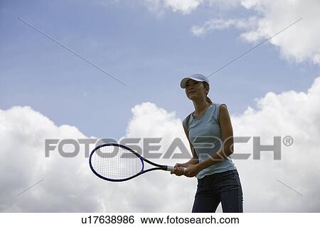 A woman holding racket View Large Photo Image Stock Photograph - A woman holding racket. Fotosearch