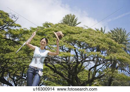 A woman standing by raising hands View Large Photo Image Picture - A woman standing by raising hands. Fotosearch