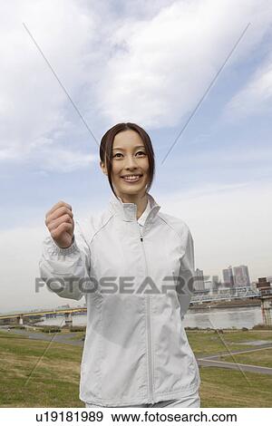 Stock Photo - A young woman walking. Fotosearch