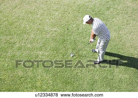 Stock Photo - Elevated view of a man playing golf. Fotosearch