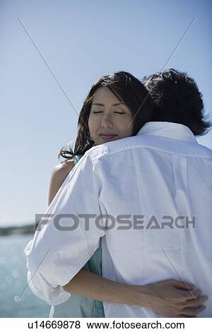 A young couple hugging each other View Large Photo Image Stock Photo - A young couple hugging each other. Fotosearch
