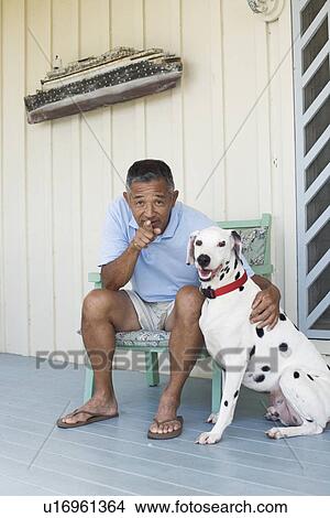 Picture - Portrait of man sitting with dog. Fotosearch