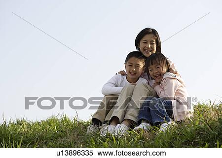 View of a mother sitting with son and daughter View Large Photo Image Stock Photography - View of a mother sitting with son and daughter. Fotosearch