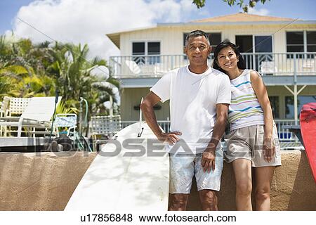 A couple standing near surfboards View Large Photo Image Stock Photo - A couple standing near surfboards. Fotosearch