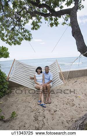 A couple sitting on hammock View Large Photo Image Stock Photography - A couple sitting on hammock. Fotosearch