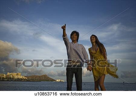 A young couple holding hands View Large Photo Image Stock Photograph - A young couple holding hands. Fotosearch