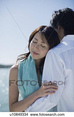 A young couple hugging each other View Large Photo Image Picture - A young couple hugging each other. Fotosearch