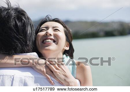 Stock Photo - A young couple hugging each other. Fotosearch
