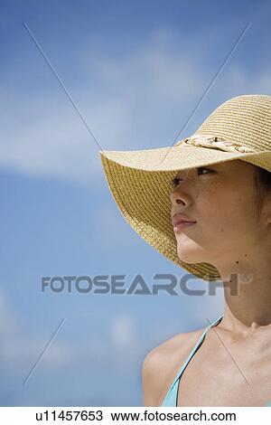 A woman wearing hat looking away View Large Photo Image Stock Image - A woman wearing hat looking away. Fotosearch