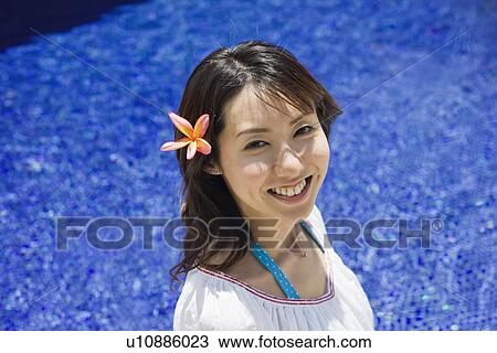 Elevated view of a smiling young woman View Large Photo Image Stock Image - Elevated view of a smiling young woman. Fotosearch