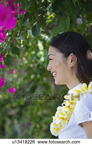 Stock Photograph - Profile of a young woman laughing. Fotosearch