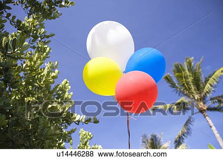 Low angle view of air balloons against sky View Large Photo Image Stock Photo - Low angle view of air balloons against sky. Fotosearch