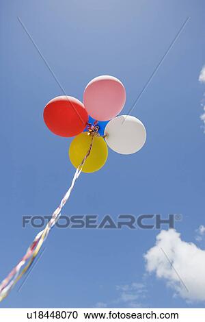 Low angle view of balloons in air View Large Photo Image Stock Image - Low angle view of balloons in air. Fotosearch