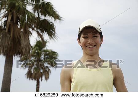 Portrait of a young man smiling View Large Photo Image Stock Photo - Portrait of a young man smiling. Fotosearch