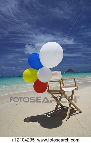 View of air balloons on wooden chair at beach View Large Photo Image Stock Photography - View of air balloons on wooden chair at beach. Fotosearch