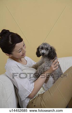 A young woman holding a dog View Large Photo Image Stock Photography - A young woman holding a dog. Fotosearch