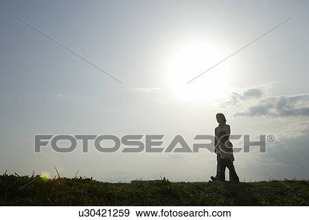 Mother and daughter walking together on sunny day View Large Photo Image Stock Photo - Mother and daughter walking together on sunny day. Fotosearch