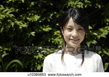 Portrait of a young woman smiling View Large Photo Image Stock Image - Portrait of a young woman smiling. Fotosearch